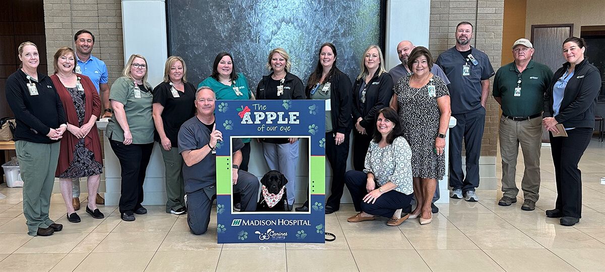 Apple pictured with a group of Madison Hospital's employees
